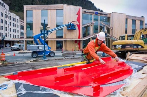 Coleman Stanford of Dawson Construction prepares bright red metal panels for installation onto the new Walter Soboleff Center on April 29.